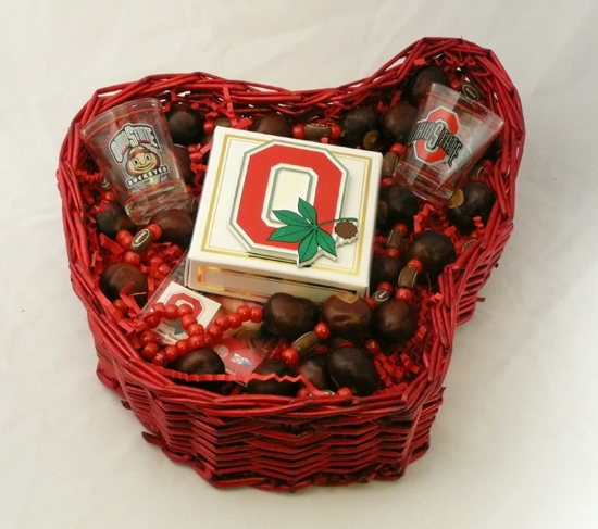 OSU Tailgate Kit - A red shaped Ohio basket filled with two Ohio State University shot glasses, two buckeye necklaces, box of 4 hand dipped buckeye candies, and four temporary tattoos